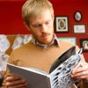PhD student Alec Falkenham, inventor of the cream, studies a book of tattoos (Photo: Bruce...